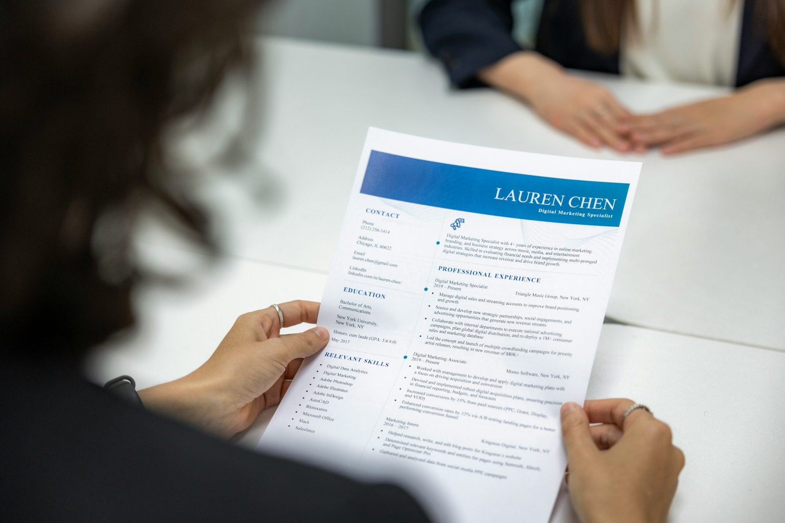 Close-up of someone reading a CV closely during an interview