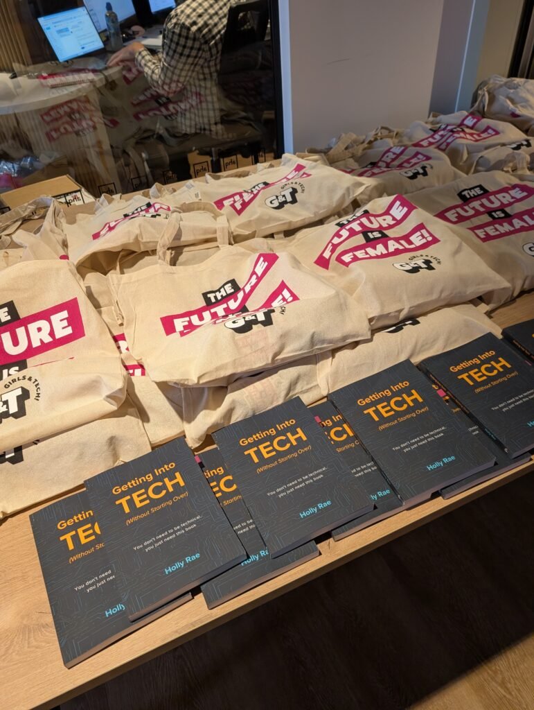 Girls and Tech tote bags lined up with copies of Getting Into Tech (Without Starting Over) ready for attendees