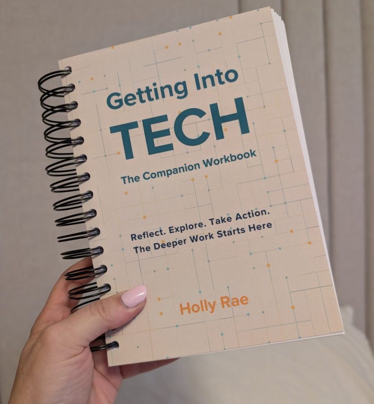 The Companion Workbook A left hand, holding the light coloured spiral bound book of getting into tech - the companion workbook